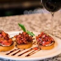 Roasted Garlic Bruschetta · Roma Tomato, Garlic and Red Onion. Served on a Fresh Baked Baguette Bread and topped with Ba...