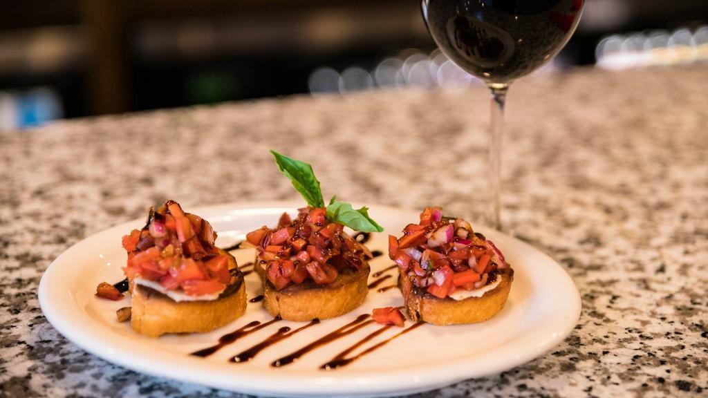 Roasted Garlic Bruschetta · Roma Tomato, Garlic and Red Onion. Served on a Fresh Baked Baguette Bread and topped with Balsamic Reduction and Basil