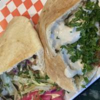 Falafel Pocket Pita · Baked Egyptian pita filled with well harvested cabbage salad and tomatoes then splashed with...
