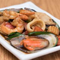 Seafood Kra Prao · Shrimp, mussels, calamari, imitation crab in a spicy garlic soy sauce with basil, bell peppe...
