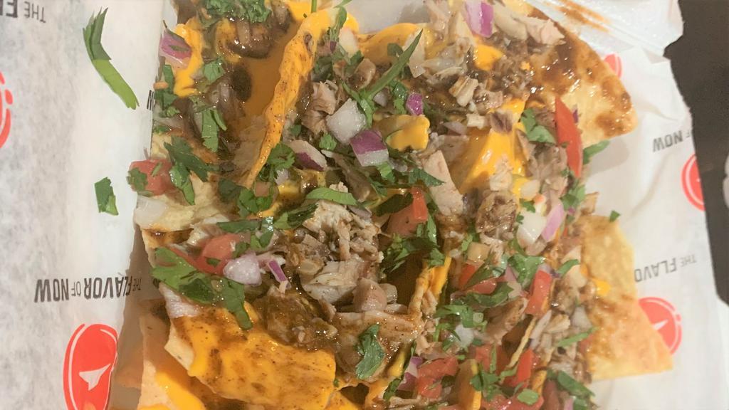 Jerk Chicken Nachos(Spicy) · Tortilla chips smothered in cheese, cilantro, tomatoes, jalapeño peppers and jerk chicken with jerk sauce.