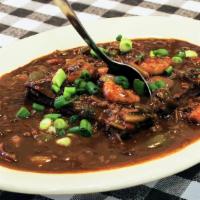 Grits & Gumbo · Traditional gumbo made with roux, okra, andouille sausage, and shrimp.
