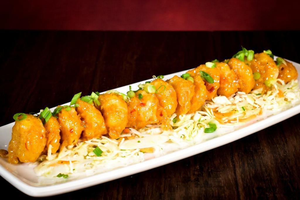 Pow Wow Shrimp · Hand-breaded shrimp lightly fried and tossed in our spicy, creamy sweet chili sauce topped with diced green onions on shredded cabbage.