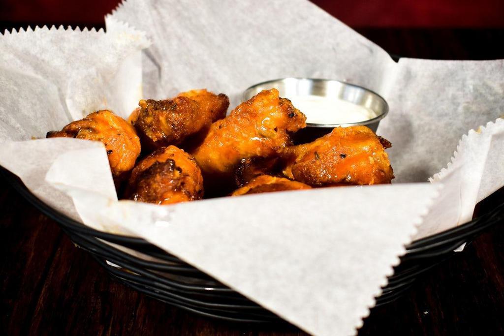 Smoked Wings · Full pound of our slow-smoked chicken wings flash-fried crispy and served naked or tossed in your choice of Buffalo sauce or Black Diamond Hot sauce.