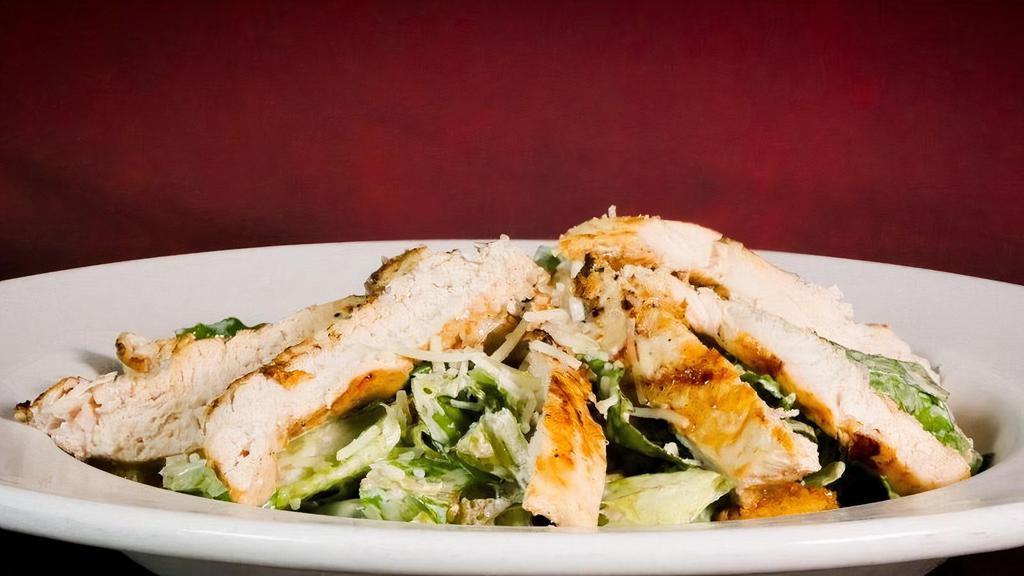 Lodge Chicken Caesar · Hearts of romaine & scratch baked garlic croutons tossed in Caesar dressing and topped with marinated grilled or fried chicken & parmesan cheese.