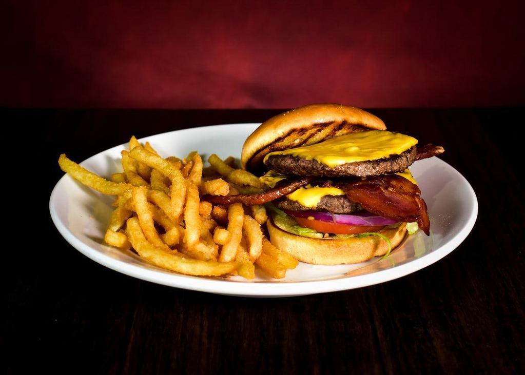 Classic Cheeseburger · Two quarter pound beef patties with American cheese. Served with french fries.