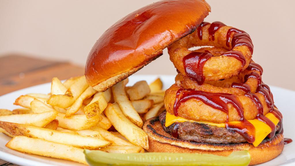 The Cowboy · Barbecue sauce and cheddar cheese, topped with onion rings.