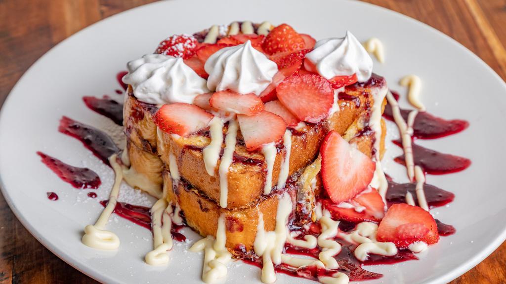Stuffed Brioche French Toast · Two pieces, filled and topped with home-made cream fraiche, topped with fresh strawberries or blueberries and a blackberry sauce.