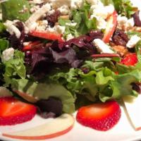 Waldorf Salad · Organic Mixed Greens, Apples, Strawberries, Raisins,
crumbled Feta, and crunchy Walnuts, top...