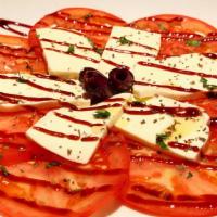 Caprese Salad · Fresh Mozzarella and Tomato salad garnished with
Kalamata Greek Olives and Basil. Drizzled w...