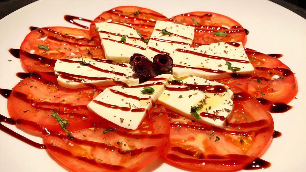 Caprese Salad · Fresh Mozzarella and Tomato salad garnished with
Kalamata Greek Olives and Basil. Drizzled with our Signature Balsamic Glaze and extra-virgin olive oil