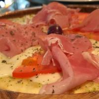 Proscuitto Pizza · Flat-bread pizza with thin-sliced Prosciutto, Mozzarella cheese, Fresh Tomatoes, + our signa...