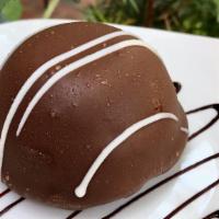 Chocolate Bombe · A rich chocolate cake base is layered with milk chocolate & white chocolate mousse and cover...