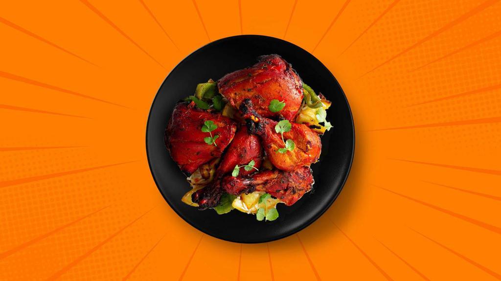 Tandoori Spring Chicken · Spring chicken marinated in a traditional tandoori masala and hung yogurt, skewered and cooked over a charcoal fire in an Indian clay oven.