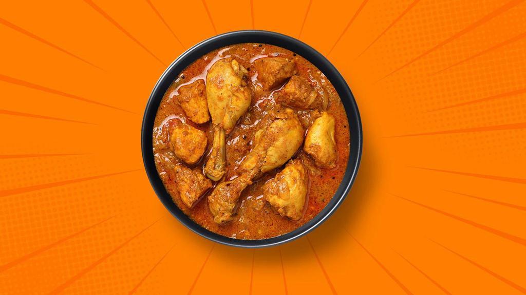 Capital Chicken Curry · Bone in/ boneless chicken pieces simmered in a brown onion and tomato curry, seasoned with fresh herbs and whole Indian spices. Served with a side of aromatic white rice.