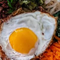 Triple Meat Bibimbap · Your choice of 3 proteins with white rice, kimchi, shredded carrots, cucumber, scallions, se...