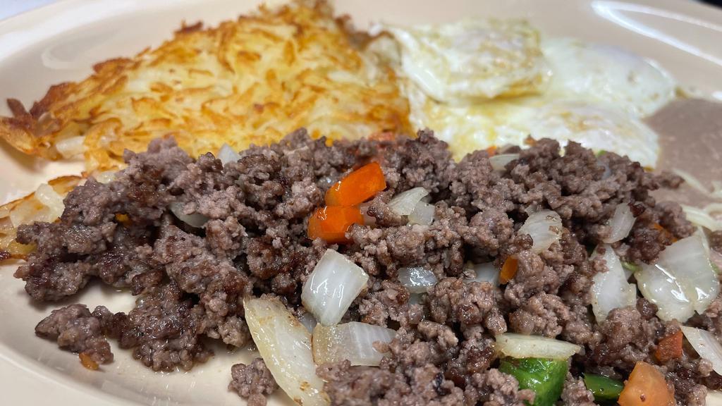 Huevos Con Picadillo · Two farm-fresh eggs prepared with ground beef, pepper, tomatoes, and onions. Served with hash browns, refried, and a flour tortilla.
