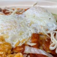 Enchiladas Montadas · Three cheese enchiladas topped with two farm-fresh eggs. Served with rice, refried beans, an...