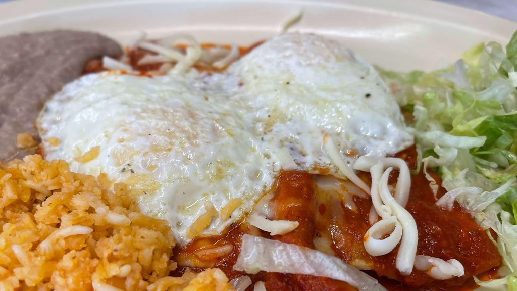Enchiladas Montadas · Three cheese enchiladas topped with two farm-fresh eggs. Served with rice, refried beans, and a flour tortilla.