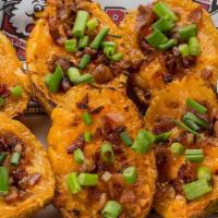 Potato Skins · Idaho russets halved and topped with Cheddar Jack cheese, bacon and sour cream.