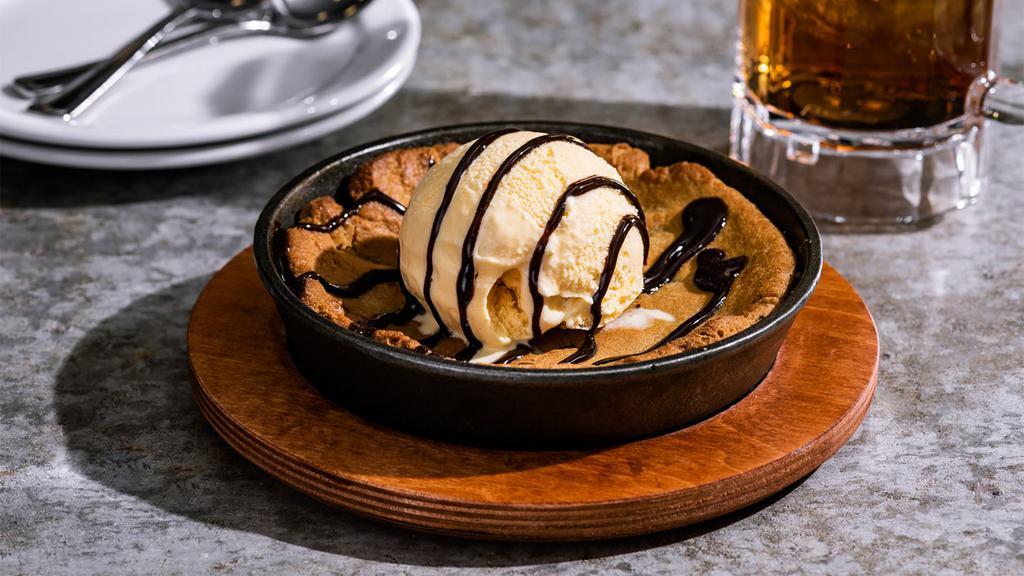 Skillet Chocolate Chip Cookie · Topped with vanilla ice cream, hot fudge. 1180 cal.