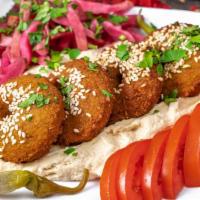 Falafel (6 Pieces) · six pieces with tomatoes and pickles and pita bread