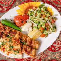 Chicken Kebab Plate · Served with two sides, hummus, salad, rice, French fries.
