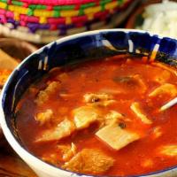 Menudo · Traditional Mexican soup, made with cow's stomach (tripe) in broth with a red chili pepper b...