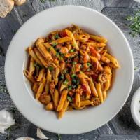 Jambalaya Pasta · Andouille sausage, chicken, shrimp and fish tossed in a spicy tomato cream sauce with penne ...