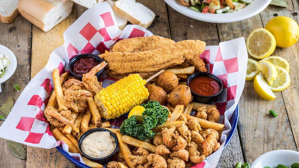 Seafood Combo Platter · Shrimp, catfish and crawfish. Hand battered, hand seasoned and perfectly fried. Served with Cajun seasoned fries, jalapeño hush puppies and dipping sauces.