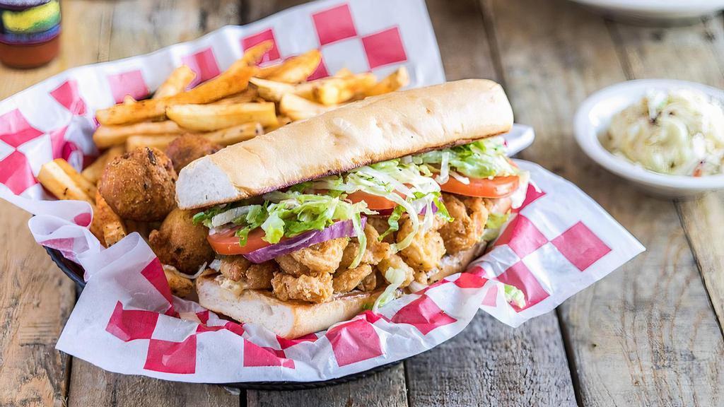 Fried Shrimp Po'Boy · Fried shrimp on a toasted French roll, with all the fixins, Cajun seasoned fries and jalapeño hush puppies.