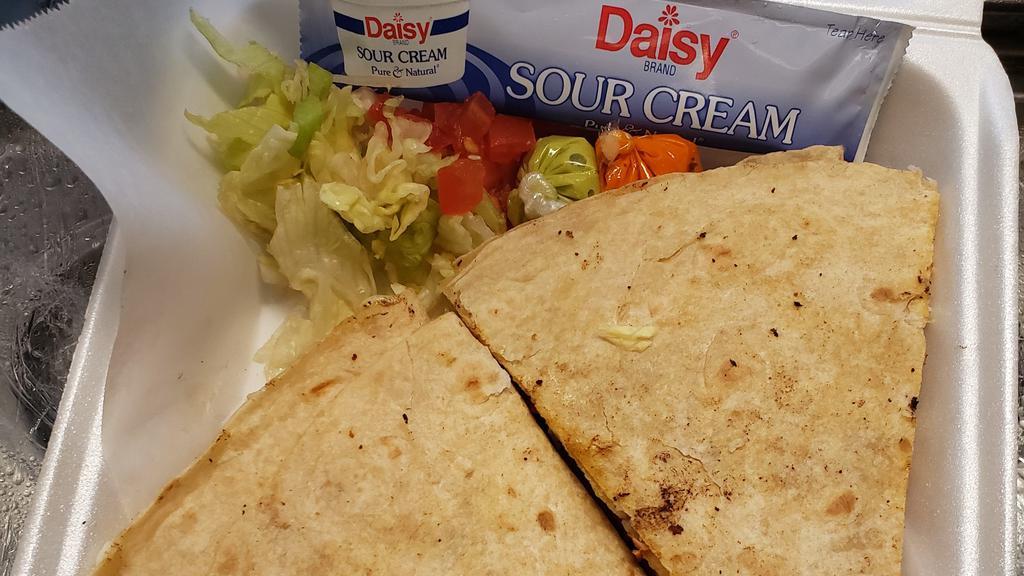 Quesadillas · Choice meat ground beef, fajita, chicken, pastor, flour tortilla fill with mix cheese, lettuce and tomato on the side.