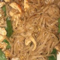 Pad Thai · Includes green onions, egg, rice noodles. Garnished with a lime wedge, peanut, and cilantro....