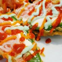 Hot Attack (4) · Spicy. Cheese stuffed jalapeno topped with shredded crab stick and tempura fried drizzled wi...