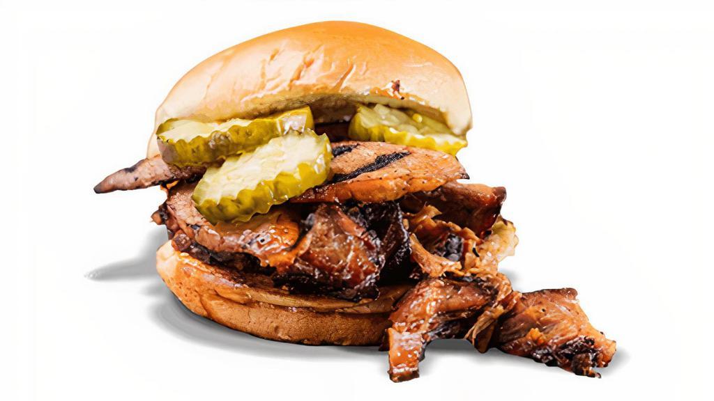 The Manhandler Sandwich · Choice of Texas Beef Brisket or Georgia Chopped Pork piled high with Hot Link Sausage. Served with your choice of one side and spicy Hell-Fire Pickles.
