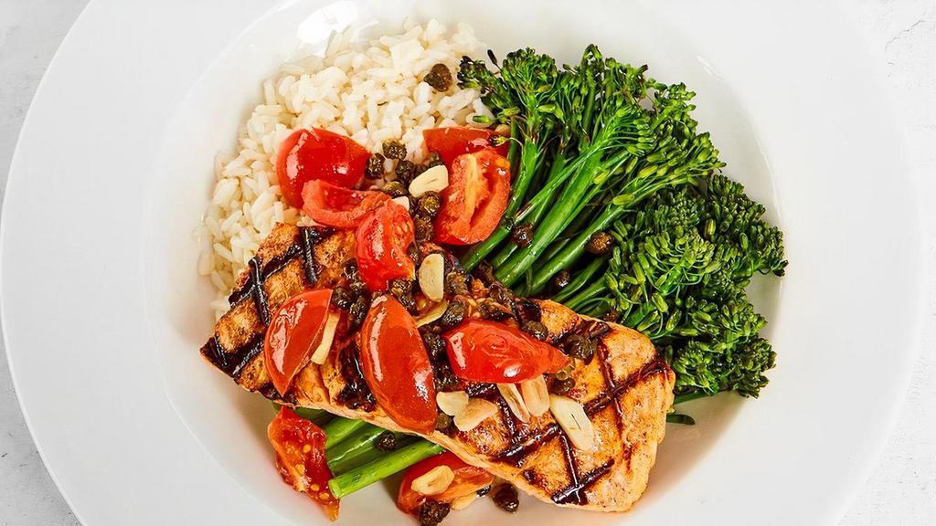 Garlic Caper Grilled Salmon · Cherry tomatoes, lemon, white wine served with your choice of two sides. We recommend white rice & broccolini