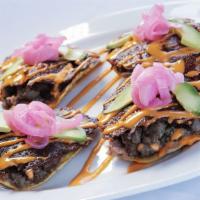 Volcanes · Crunchy tostada with our delicious refried beans and beef fajitas topped with a mix of melty...