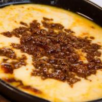 Choriqueso · Sizzling skillet filled with melted Muenster cheese and real Mexican-style chorizo. Simply d...