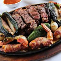Parrillada Prime · A combination of USDA Prime ribeye and our flavorful Laredo shrimp. Served with poblano pepp...