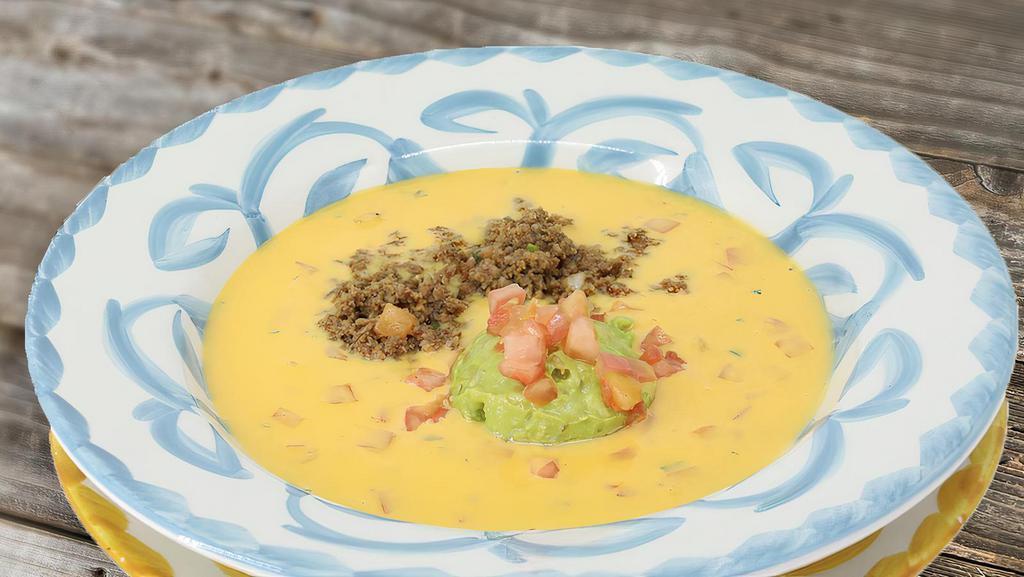 Large Queso Compuesto · Our Chile Con Queso, topped with fresh guacamole and taco meat.