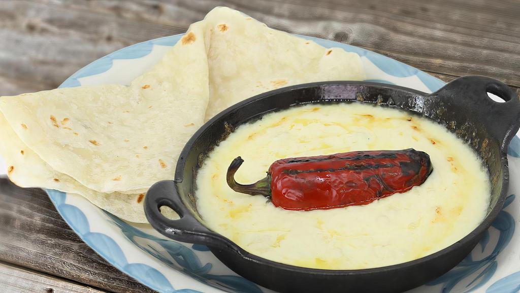 Queso Flameado · Melted jack cheese, chorizo, jalapeño sausage or carne molida.