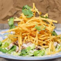 Tijuana Salad · Romaine lettuce, Caesar dressing and
fried tortilla strips.