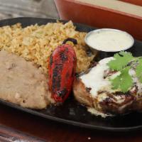 Filet Asada · Sizzling 8 oz choice bacon wrapped beef tenderloin topped with lime pepper butter