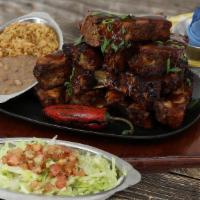Large Chipotle Smoked Ribs · 13 Slow roasted baby back ribs, basted with our spicy chipotle BBQ sauce. Served with Mexica...