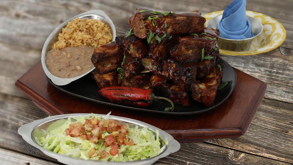 Large Chipotle Smoked Ribs · 13 Slow roasted baby back ribs, basted with our spicy chipotle BBQ sauce. Served with Mexican salad.