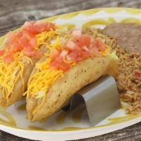 Puffy Tacos · 2 carne molida tacos with lettuce, guacamole, cheddar cheese and tomatoes Served with rice a...