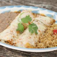 Soft Chicken Tacos (Enchiladas) · 2 Hand rolled flour tortillas filled with roasted chicken, covered with ranchera sauce and m...