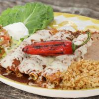 Spicy Red Enchiladas · 3 Roasted chicken enchiladas in hand pressed corn tortillas with Jack cheese, spicy red sauc...