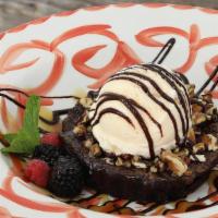 Double Chocolate Praline Brownie · Topped with toasted pecans & a praline caramel sauce with vanilla ice cream