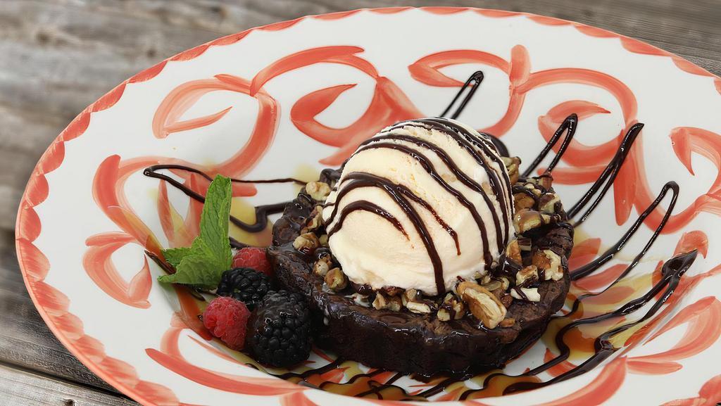 Double Chocolate Praline Brownie · Topped with toasted pecans & a praline caramel sauce with vanilla ice cream